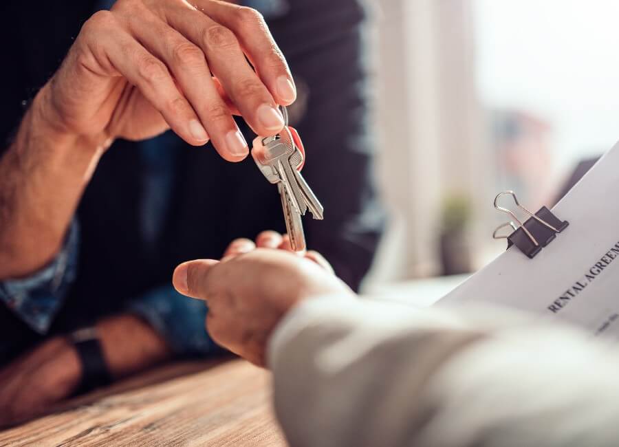 Estate Agent handing over keys to client